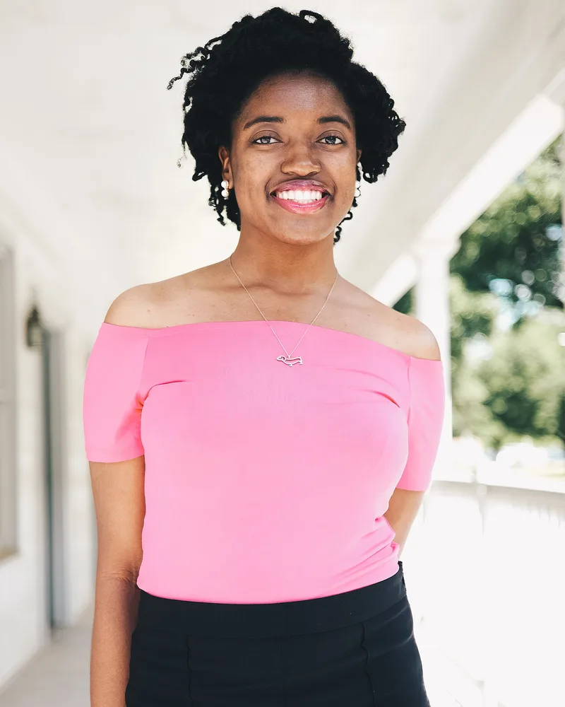 Original portrait of a woman in a pink top on a white porch